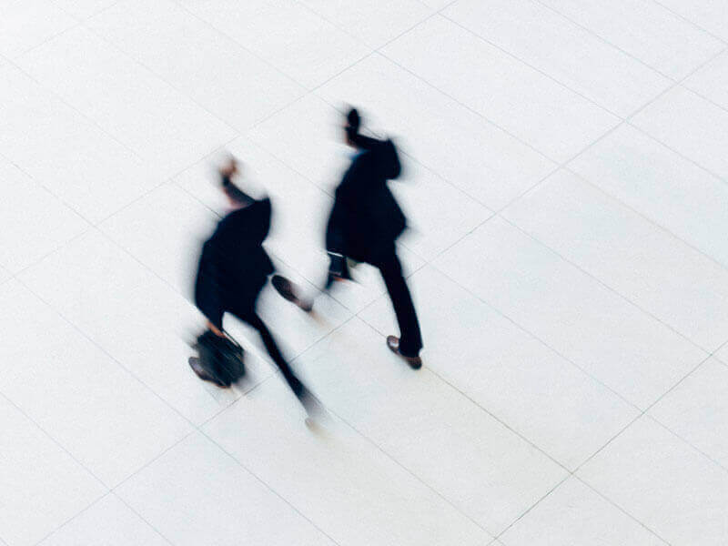 blurred motion image of two attorneys walking